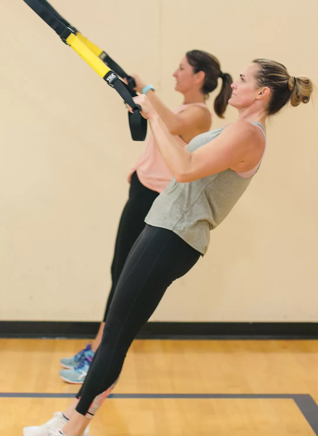 2 women doing TRX
