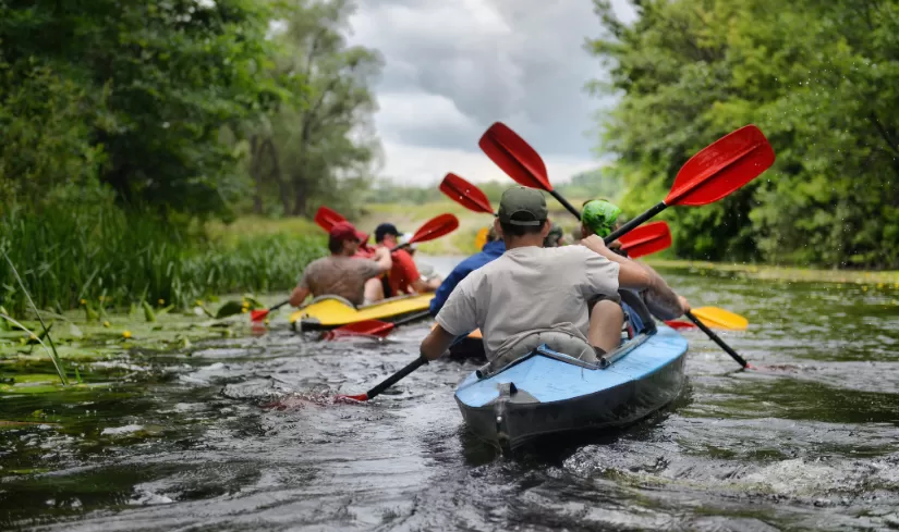 a group of people canoeing