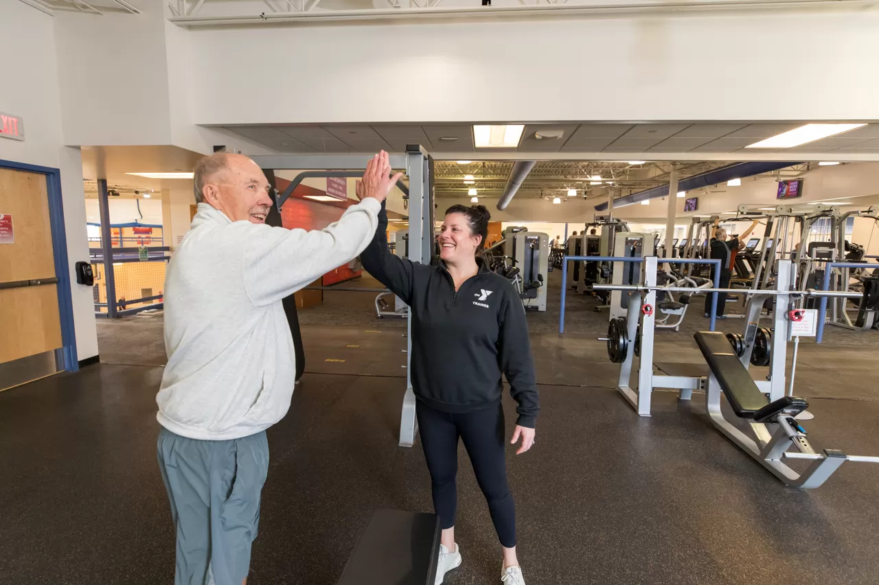 YMCA personal trainer high five with a client