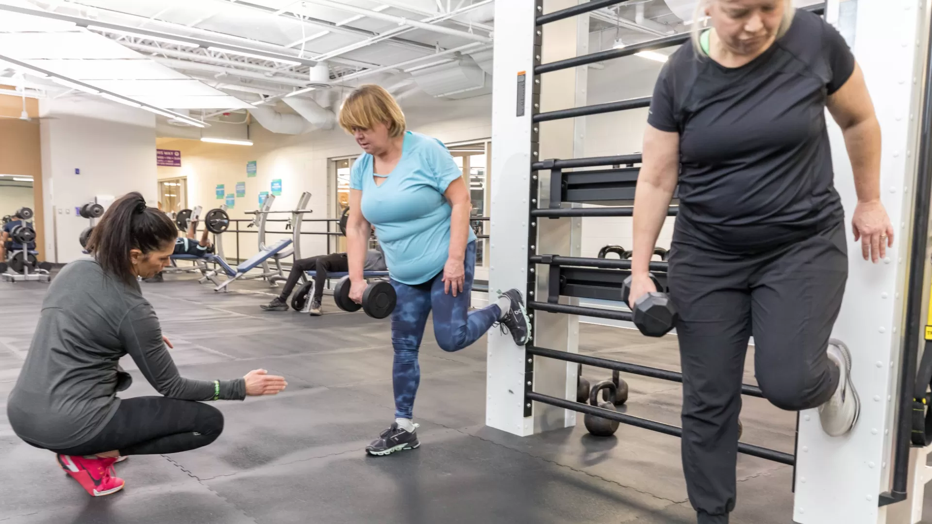 2 women working wit ha personal trainer