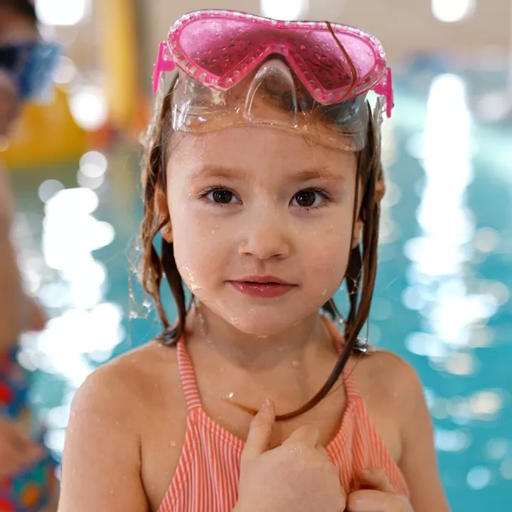 girl in the YMCA pool wearing goggles