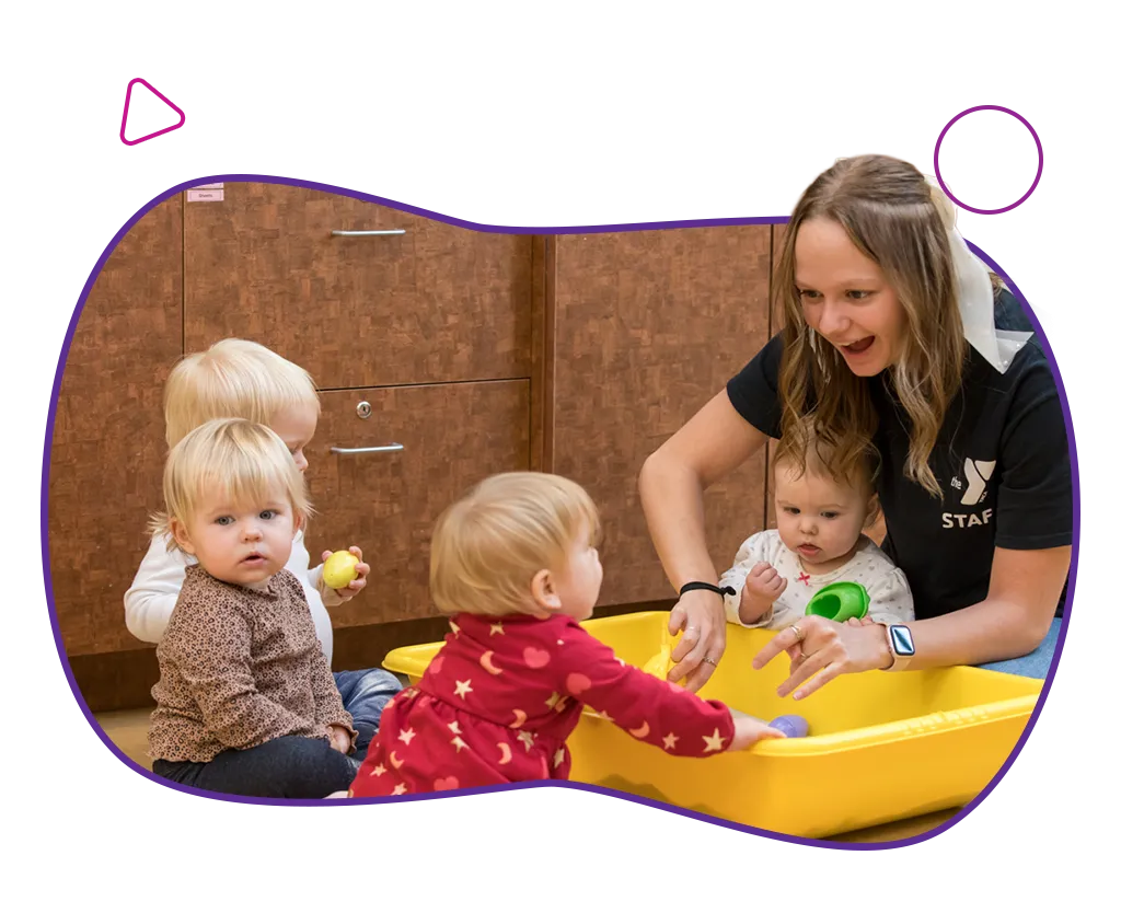 YMCA leader playing with infants