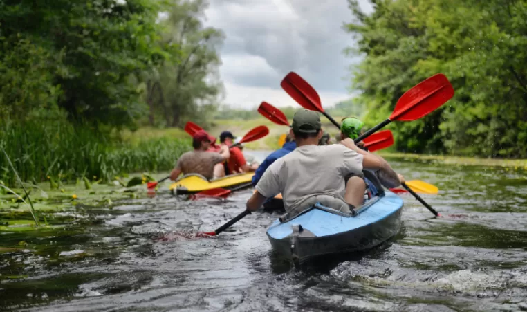 a group of people canoeing