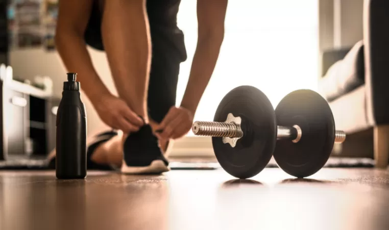 dumbbell and water bottle on the floor