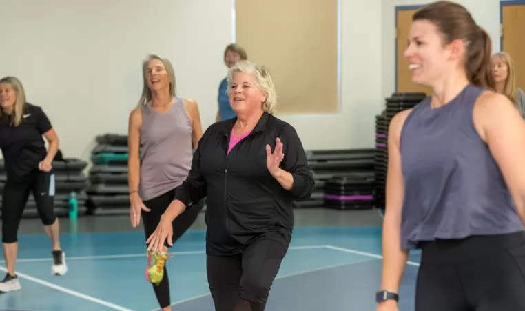 smiling woman in a group fitness class