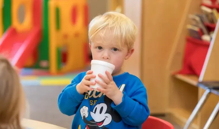 child drinking from a cup