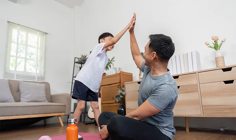 dad and son high five after workout
