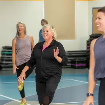 smiling woman in a group fitness class