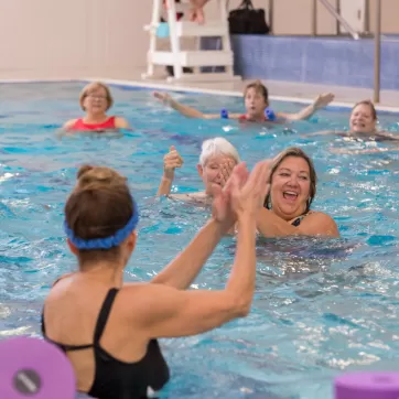 group of people in a water aerobics class