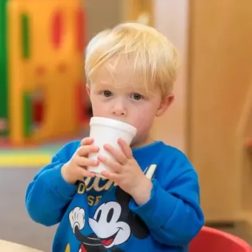 child drinking from a cup