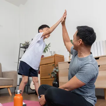 dad and son high five after workout