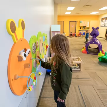 child playing with toys in child care center
