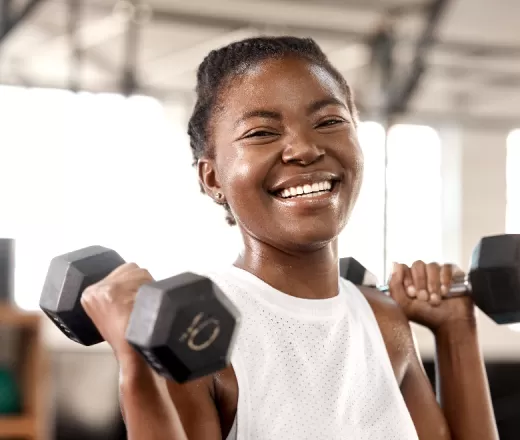 young woman holding dumbbells