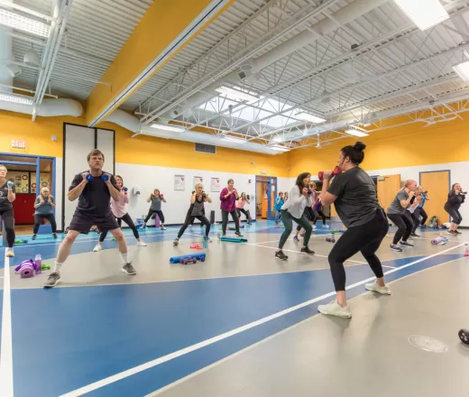 Group exercise participants lifting dumbbells
