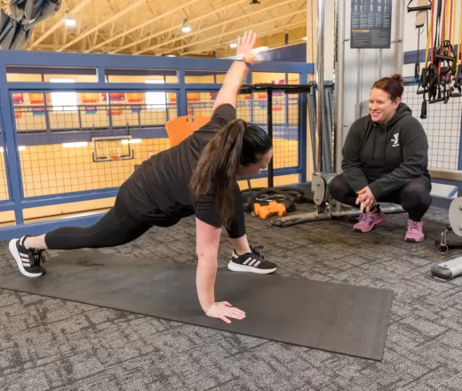 YMCA personal trainer working with a client