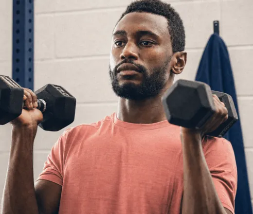 man lifting dumbbells